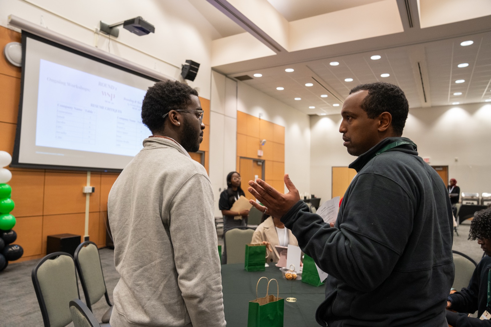A member speaking with an industry representative during resume critiques